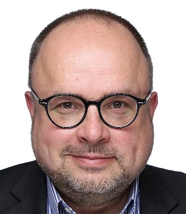 headshot oh a middle-aged man with glasses